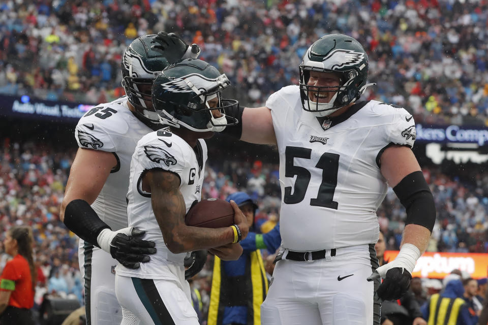 Philadelphia Eagles wide receiver DeVonta Smith, center, celebrates after his touchdown with offensive tackle Lane Johnson, left, and center Cam Jurgens, right, in the first half of an NFL football game against the New England Patriots, Sunday, Sept. 10, 2023, in Foxborough, Mass. (AP Photo/Michael Dwyer)