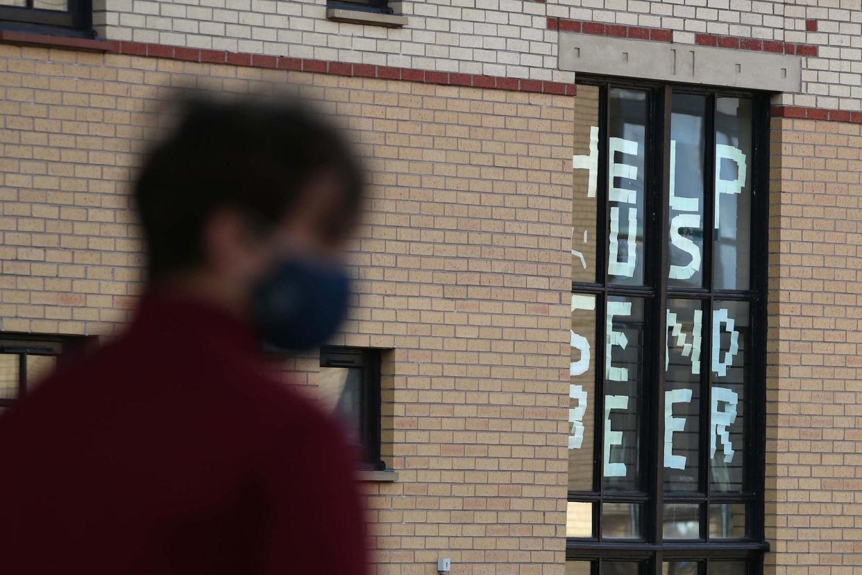 A student walks past a sign at Murano Street Student Village in Glasgow, where Glasgow University students are being tested at a pop up test centre: PA