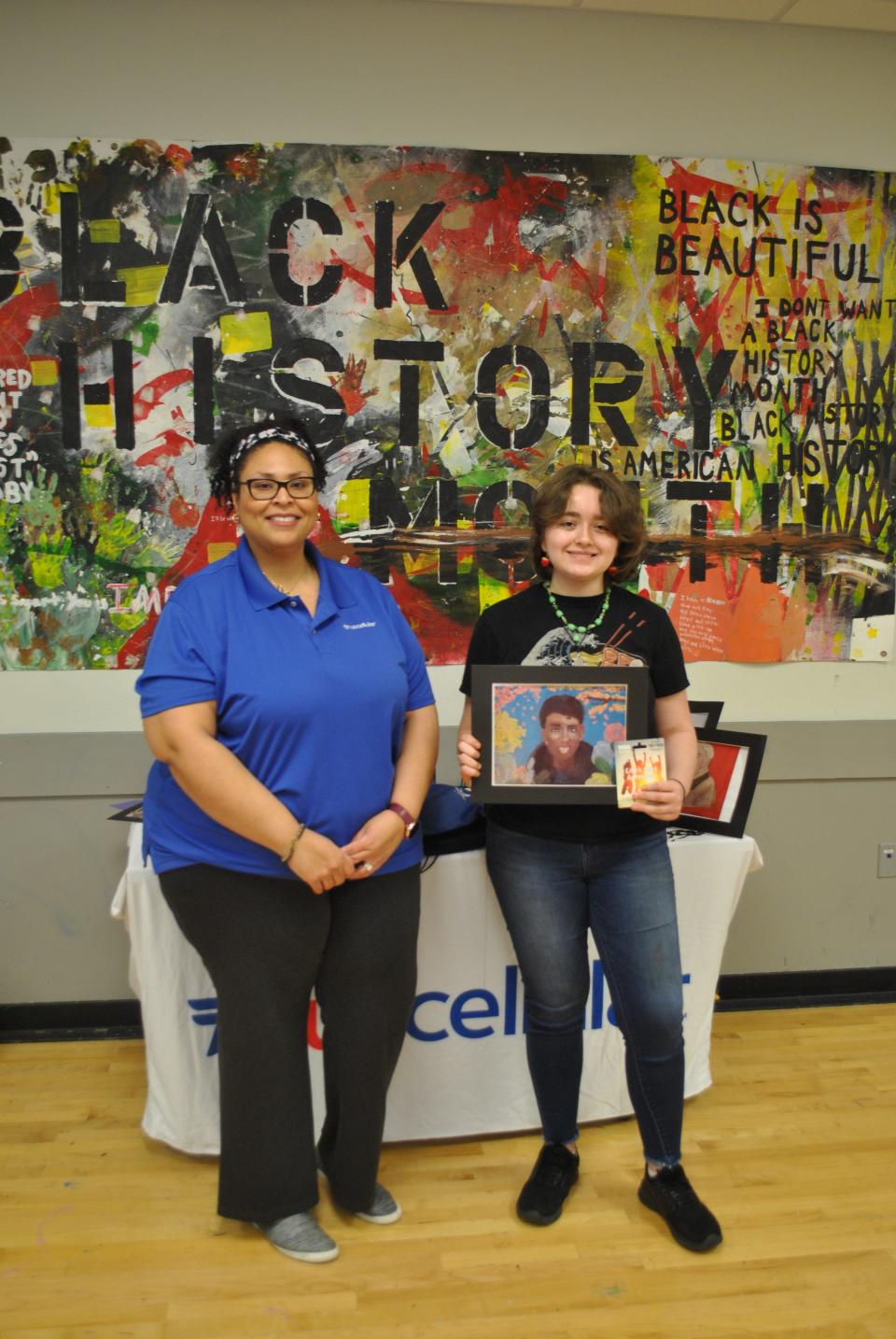First place recipient Alina Fominy (13) shows winning portrait of astronaut Mae C. Jemison. March 2022