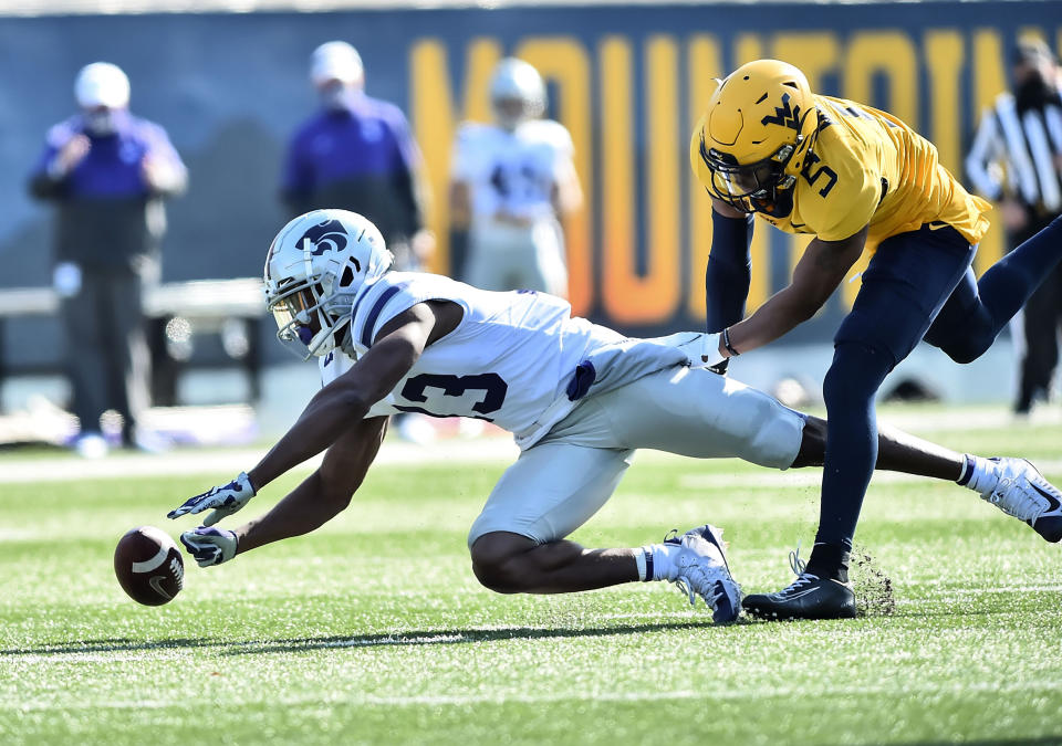 West Virginia cornerback Dreshun Miller (5) breaks up the pass intended for Kansas State wide receiver Chabastin Taylor (13) during an NCAA college football game Saturday, Oct. 31, 2020, in Morgantown, W.Va. (William Wotring/The Dominion-Post via AP)