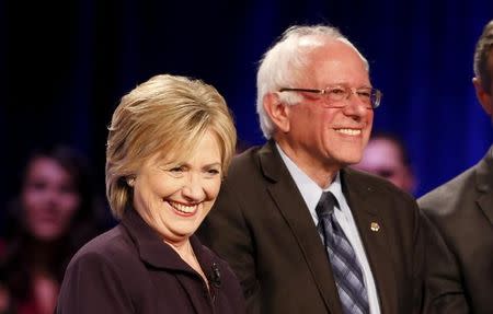 Democratic presidential candidates Hillary Clinton (L) and Bernie Sanders (R) smile at the crowd following the First in the South Presidential Candidates Forum held at Winthrop University in Rock Hill, South Carolina November 6, 2015. REUTERS/Chris Keane