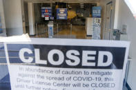 FILE - In this Friday, April 3, 2020, file photo, empty seats and aisles are seen through the window of the closed Penndot Drivers License Center in Butler, Pa. States are furloughing workers, borrowing billions, delaying construction projects and reducing aid to local governments and schools as ways to cope in response to revenue drops that are expected to top 20% in some states. (AP Photo/Keith Srakocic, File)