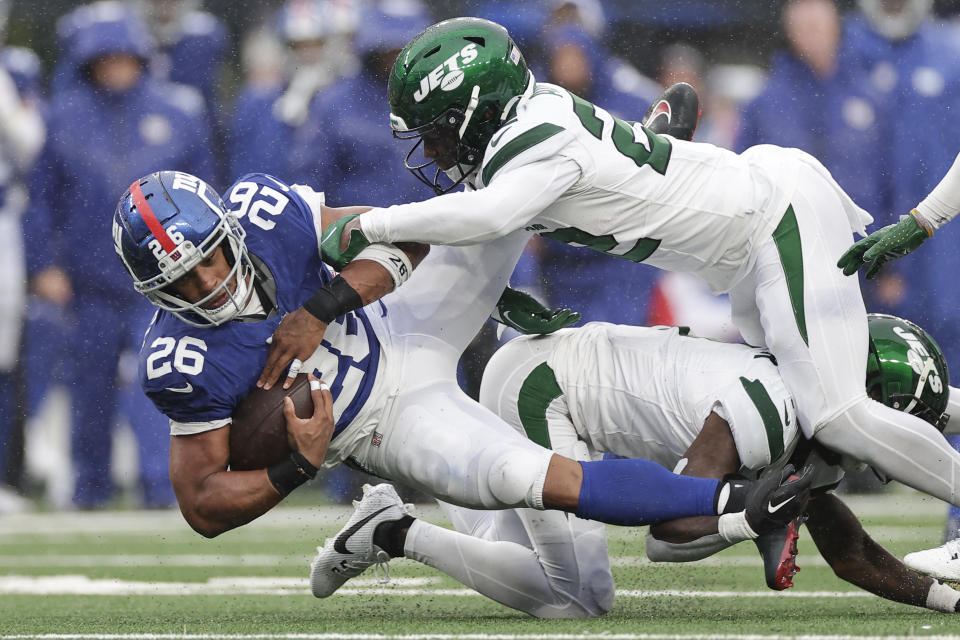 New York Giants running back Saquon Barkley (26) is tackled by New York Jets safety Tony Adams (22) during the second half of an NFL football game, Sunday, Oct. 29, 2023, in East Rutherford, N.J. (AP Photo/Adam Hunger)