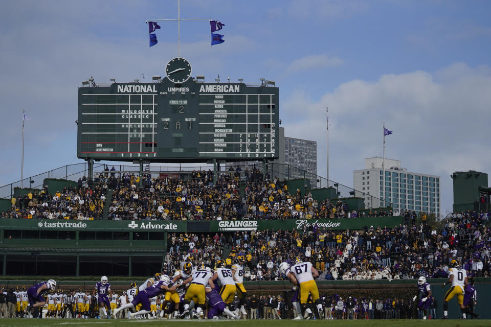 Fans watch the first half of an NCAA college football game between Iowa and Northwestern, Saturday, Nov. 4, 2023, at Wrigley Field in Chicago. (AP Photo/Erin Hooley)
