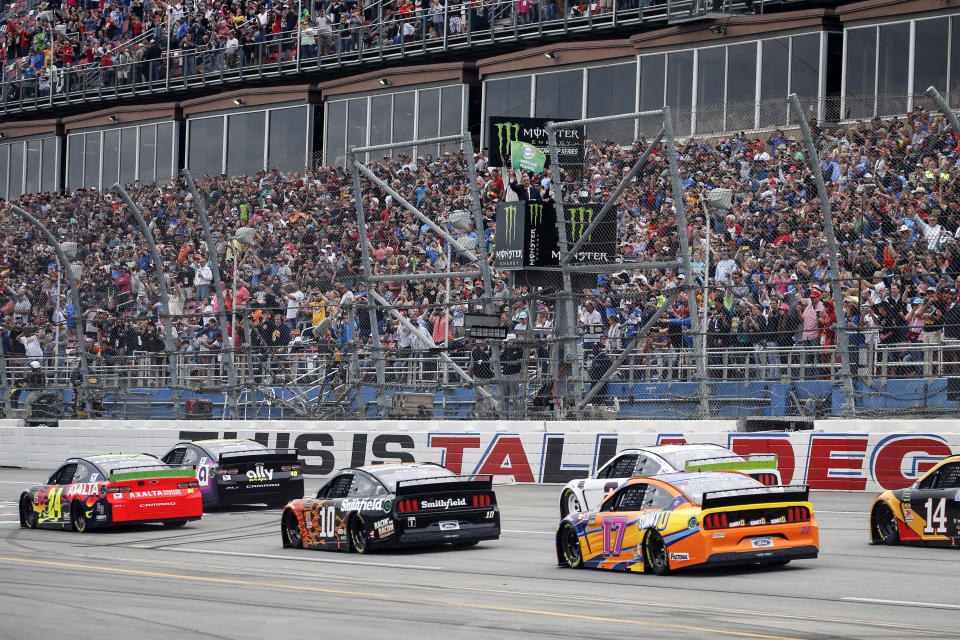 Pastor of First Baptist Church Dallas Dr. Robert Jeffress waves the green flag for the start of a NASCAR Cup Series auto race at Talladega Superspeedway in Talladega, Ala., Sunday, Oct. 13, 2019. (AP Photo/Butch Dill)