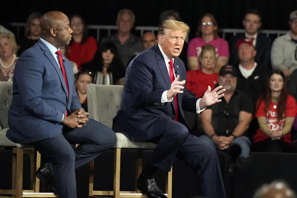 Republican presidential candidate former President Donald Trump speaks during a Fox News Channel town hall Tuesday, Feb. 20, 2024, in Greenville, S.C., as Sen. Tim Scott, R-S.C., listens. (AP Photo/Chris Carlson)