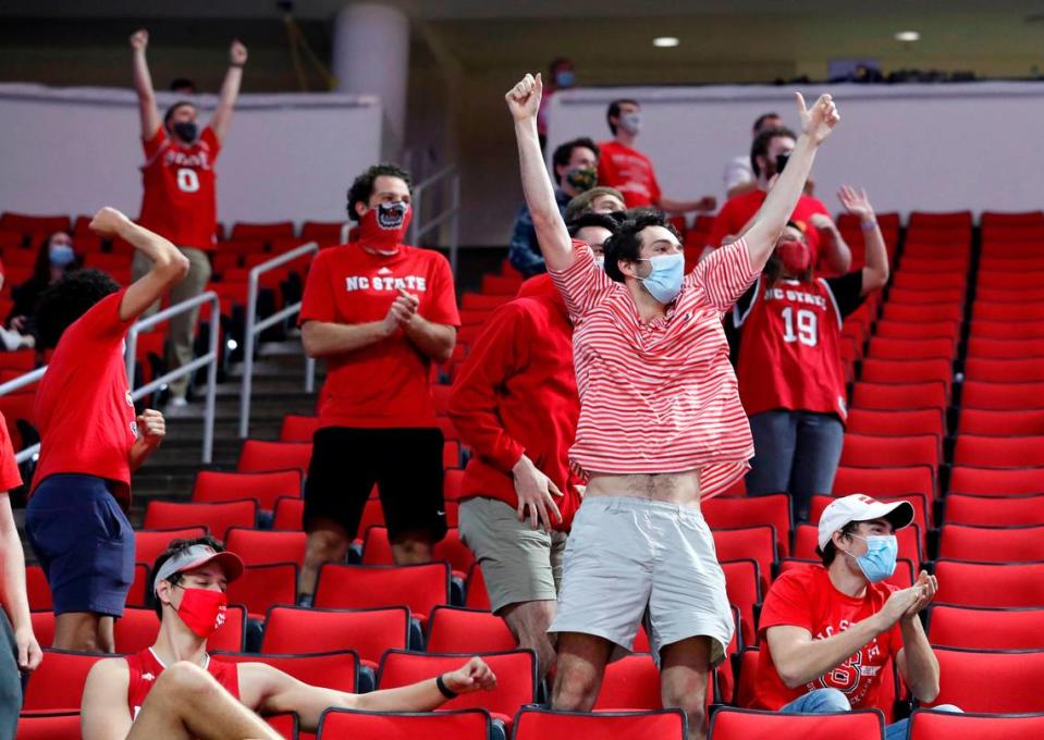 N.C. State fans react after Pittsburgh missed a free throw during the second half of N.C. State’s 65-62 victory over Pittsburgh at PNC Arena in Raleigh, N.C., Sunday, February 28, 2021.