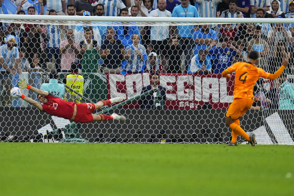 El arquero argentino Emiliano Martínez ataja el remate del neerlandés Virgil van Dijk en la tanda de penales del duelo de cuartos de final del Mundial, el viernes 9 de diciembre de 2022, en Lusail, Qatar. (AP Foto/Natacha Pisarenko)