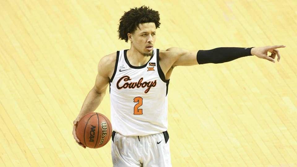 Oklahoma State guard Cade Cunningham (2)points during an NCAA college basketball game Monday, March. 1, 2021, in Stillwater, Okla. (AP Photo/Brody Schmidt)