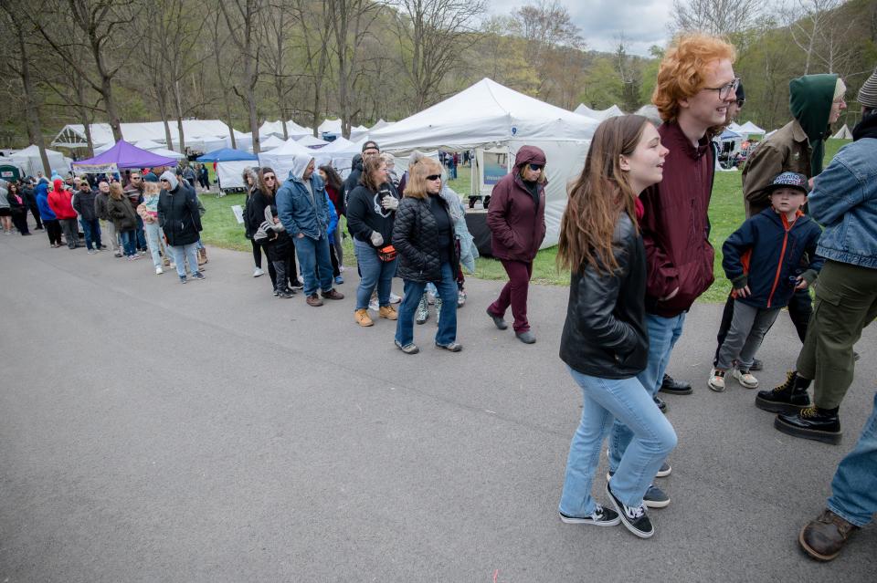 Hundreds of people wait in line for pancakes, sausage and maple syrup during the Maple Syrup Festival at Bradys Run Park.