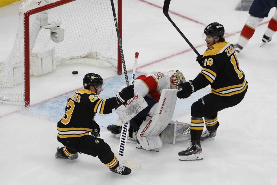 Boston Bruins' Brad Marchand celebrates his goal against the Florida Panthers with Pavel Zacha (18) during the second period of Game 1 of an NHL hockey playoff series, Monday, April 17, 2023, in Boston. (AP Photo/Winslow Townson)