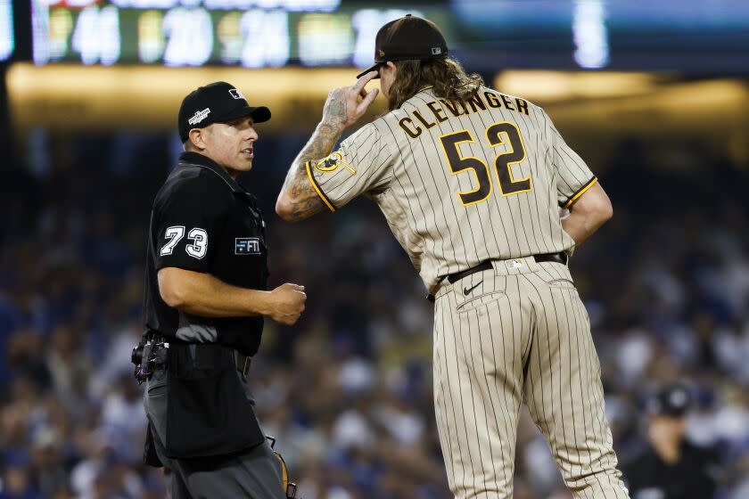 uLos Angeles, CA - October 11: San Diego Padres starting pitcher Mike Clevinger (52) speaks with umpire Tripp Gibson