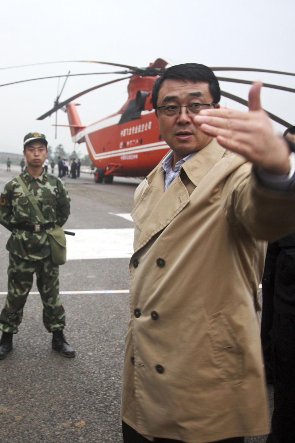 In this June 10, 2009 photo, then Chonqing city police chief Wang Lijun, right, talks at a police mission to rescue people after a landslide in Wulong county, in southwestern China's Chongqing city. A Chinese court sentenced the former police who exposed a murder by a Chinese politician's wife to 15 years in prison Monday, Sept. 24, 2012, in a decision that sets the stage for China's leadership to wrap up a seamy political scandal and move ahead with a generational handover of power. (AP Photo) CHINA OUT