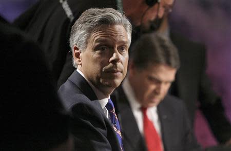 Former Utah Governor Jon Huntsman (L) and Texas Gov. Rick Perry pause during a break in a debate with other Republican presidential hopefuls at Dartmouth College in Hanover, New Hampshire, October 11, 2011. REUTERS/Scott Eells/POOL