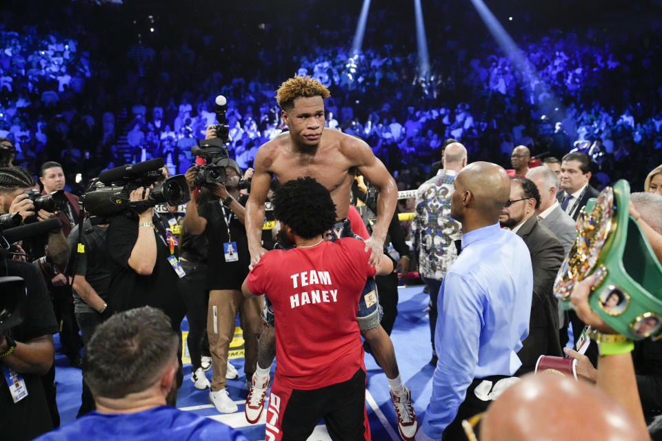 Devin Haney celebrates after defeating Vasiliy Lomachenko in an undisputed lightweight championship boxing match Saturday, May 20, 2023, in Las Vegas. Haney won by unanimous decision. (AP Photo/John Locher)