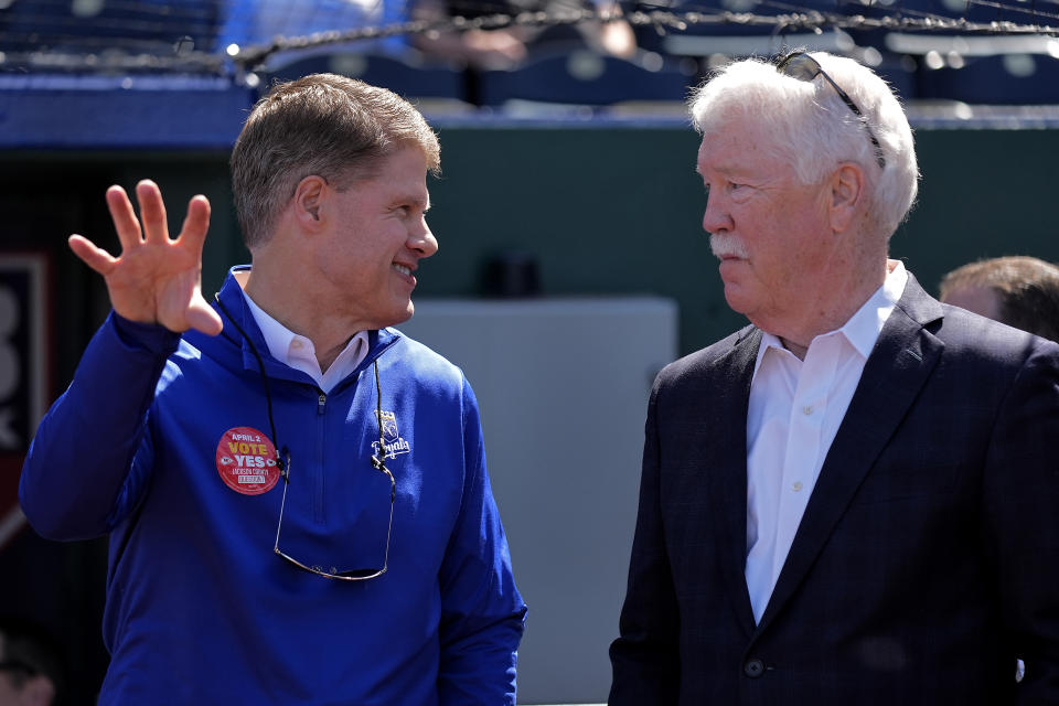 Kansas City Chiefs owner Clark Hunt, left, and Kansas City Royals owner John Sherman talk before a baseball game between the Kansas City Royals and the Minnesota Twins Thursday, March 28, 2024, in Kansas City, Mo. Jackson County voters will decide on a ballot question to extend a sales tax to fund a new stadium for the Royals and stadium improvements for the Chiefs in an election held Tuesday, April 2. (AP Photo/Charlie Riedel)