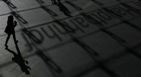 A woman casts her shadow at Berlin's main railway station Hauptbahnhof, March 8, 2011. REUTERS/Tobias Schwarz