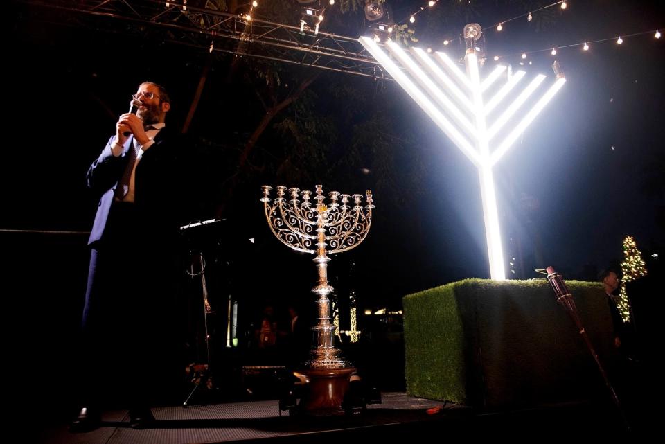 Rabbi Moshe Scheiner, of Palm Beach Synagogue, speaks before the lighting of the menorah at Bradley Park in this 2022 photo. Hanukkah begins at sundown Thursday.