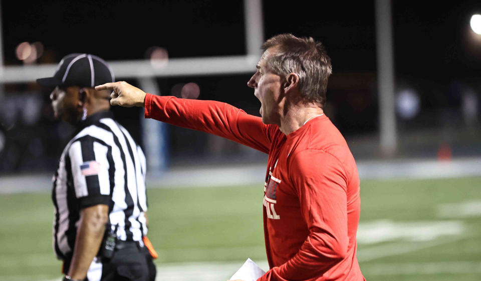 Indian Hill head coach John Rodenberg talks to his players during the Braves 21-3 win over Wyoming Friday, Oct. 13, 2023.