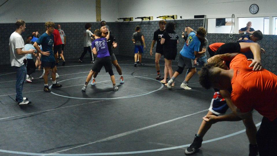 Aaron Brooks, left center, is in the middle of the action during the PAL wrestling camp Saturday at Fairgrounds Park in Hagerstown.
