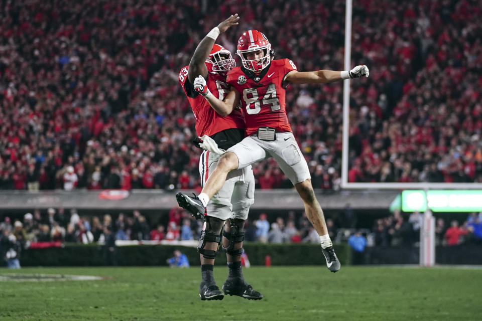 Georgia wide receiver Ladd McConkey (84) celebrates with offensive lineman Sedrick Van Pran (63) after catching a touchdown pass during the first half of an NCAA college football game against Mississippi, Saturday, Nov. 11, 2023, in Athens, Ga. (AP Photo/John Bazemore)