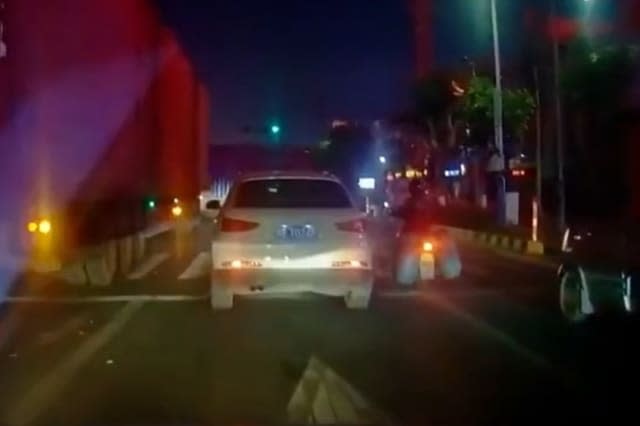 Car gets stuck underneath truck's trailer as it turns corner in southern China