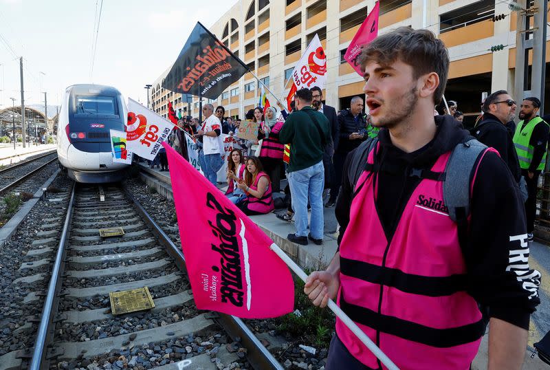 French workers on strike attend an anti-pension bill protest in Nice