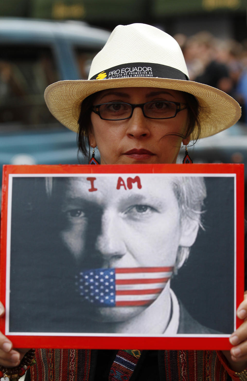 A supporter of WikiLeaks founder Julian Assange holds up a placard outside the Ecuadorian Embassy in central London, London, Thursday, Aug. 16, 2012. WikiLeaks founder Julian Assange entered the embassy in June in an attempt to gain political asylum to prevent him from being extradited to Sweden, where he faces allegations of sex crimes, which he denies. WikiLeaks chief Julian Assange was granted political asylum by Ecuador on Thursday, setting up a standoff with the British government, which has vowed to block his exit from the country. (AP Photo/Sang Tan)