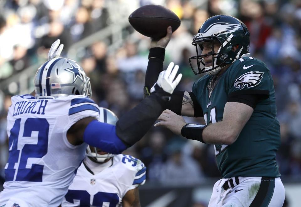 Philadelphia Eagles' Carson Wentz passes against Dallas Cowboys' Barry Church during the first half of an NFL football game Sunday, Jan. 1, 2017, in Philadelphia. (AP Photo/Michael Perez)