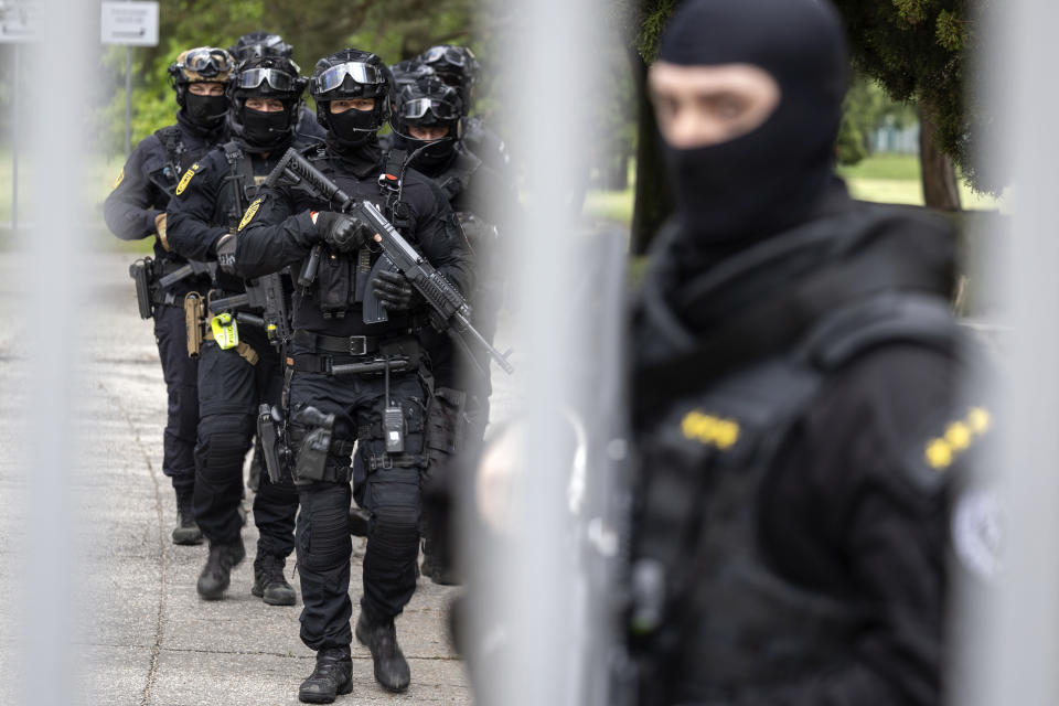 Policemen guard the area as they wait for the suspect, in shooting of Slovakia's Prime Minister Robert Fico, to be brought to court in Pezinok, Slovakia, Saturday, May 18, 2024. Officials in Slovakia say Prime Minister Robert Fico has undergone another operation two days after his assassination attempt and remains in serious condition. (AP Photo/Tomas Benedikovic)