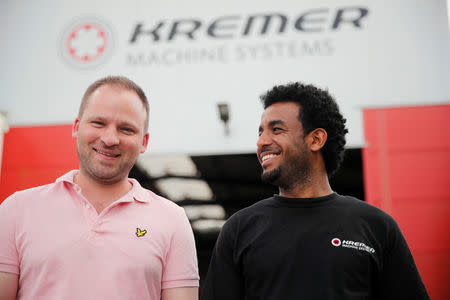 Tilman Mues, managing partner of German plant engineering firm Kremer Machine Systems and his employee and immigrant from Eritrea Merhawi Tesfay during a Reuters interview in Gescher near Muenster, Germany, August 4, 2017. Picture taken August 4, 2017. REUTERS/Wolfgang Rattay