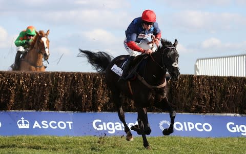 Black Corton and Bryony Frost clear the last fence before going on to win The Sodexo Reynoldstown Novices' Steeple Chase - Credit: Julian Herbert/PA Wire