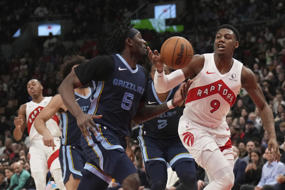 Toronto Raptors guard RJ Barrett (9) and Memphis Grizzlies guard Vince Williams Jr. (5) battle for the ball during the second half of an NBA basketball game in Toronto, Monday Jan. 22, 2024. (Nathan Denette/The Canadian Press via AP)