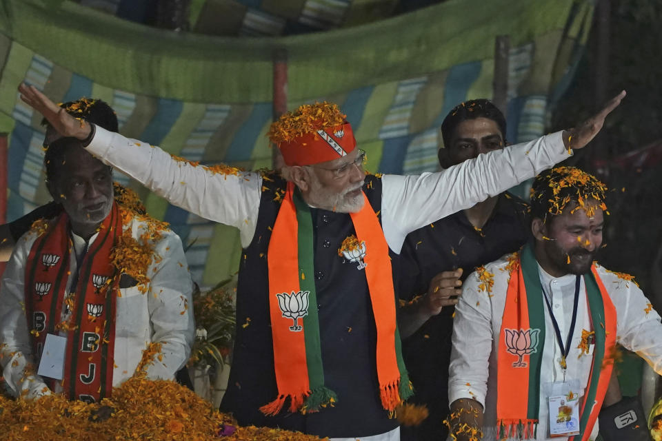 FILE - Indian Prime Minister Narendra Modi greets supporters as he arrives for an election campaign rally of his Bharatiya Janata Party (BJP) in Hyderabad, India, Monday, Nov. 27, 2023. Voters in neighboring India, the world’s most populous country, will head to the polls in mid-2024 for a general election that is likely to bring Prime Minister Narendra Modi of the right-wing Hindu nationalist Bharatiya Janata Party a third consecutive term. (AP Photo/Mahesh Kumar A., File)