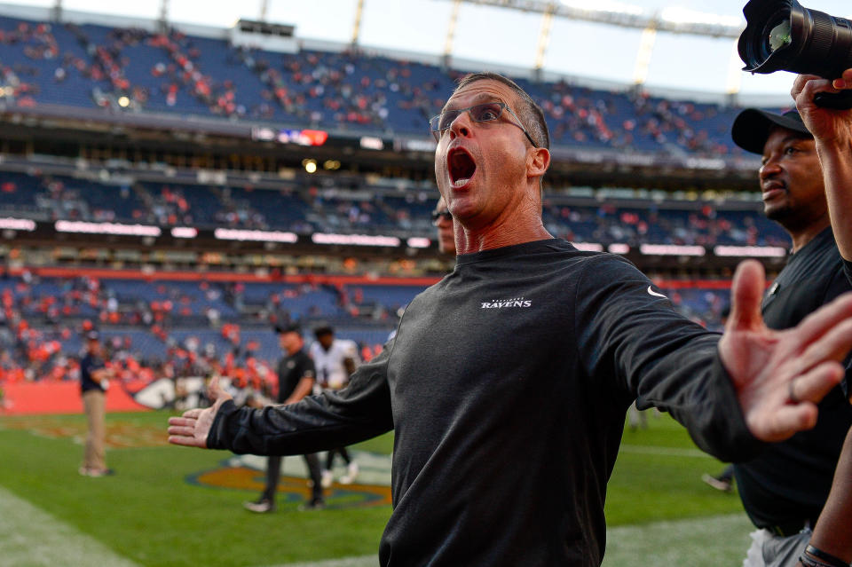 Head coach John Harbaugh of the Baltimore Ravens reacts as he sees a friend in the stands as he walks off the field after a 23-7 win over the Denver Broncos at Empower Field at Mile High on October 3, 2021 in Denver, Colorado.