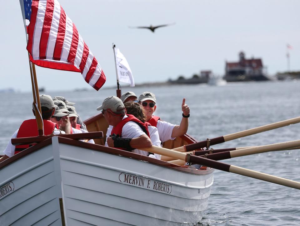 Coast Guard Rear Adm. John Mauger gives a thumbs up after he and others row the Mervin F Roberts fully restored 1930s rescue boat successfully to the Wood Island Life Saving Station in Kittery, Maine, Friday, Sept. 30, 2022.