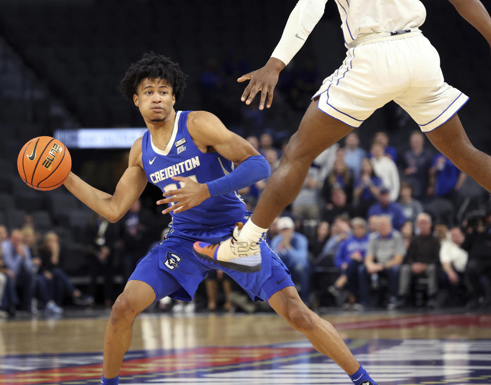 Creighton guard Trey Alexander (23) goes to throw a pass around BYU guard Rudi Williams during the first half of an NCAA college basketball game Saturday, Dec. 10, 2022, in Las Vegas. (AP Photo/Ronda Churchill)