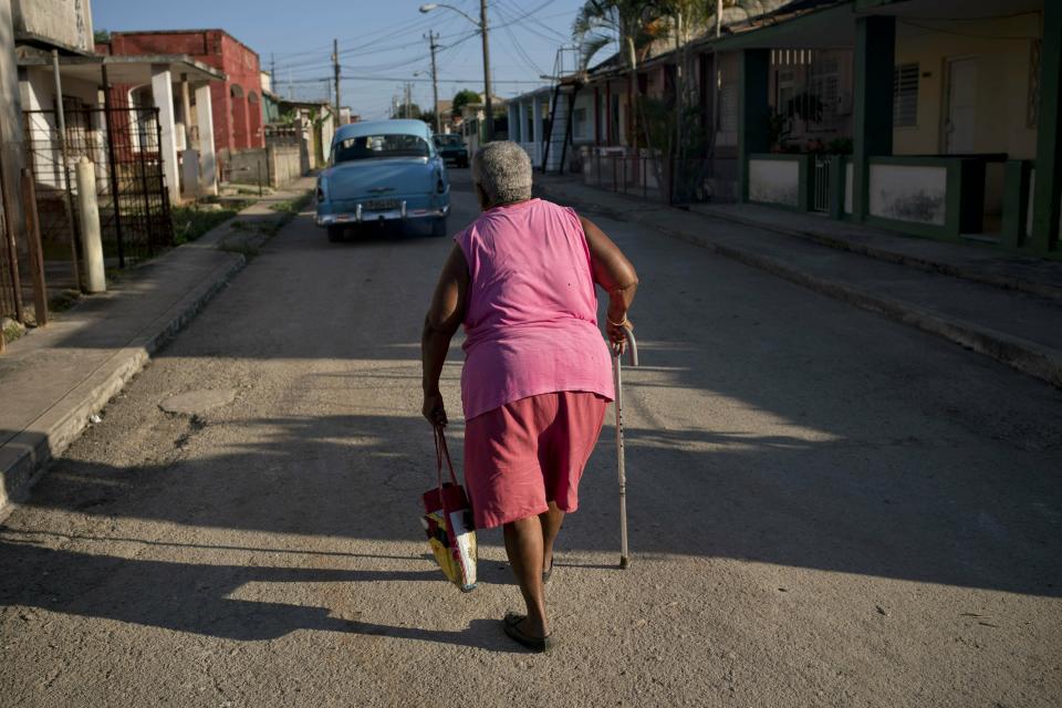 Pura Castell walks to a government-run butcher shop to buy chicken, after failing to find chicken the previous day in Bauta, Cuba, Friday, April 12, 2019. “I’ve taken care of myself my whole life,” said Castell, a retired janitor. “I don’t just sit on my hands. I’m worn out but I walk all over town.” (AP Photo/Ramon Espinosa)