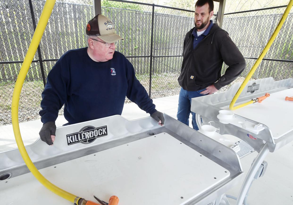 Jack Bock, left, with the S.O.N.S. of Lake Erie, talks with Tony Pianta, Harbormaster for the Erie-Western Pennsylvania Port Authority, about a newly-opened fish cleaning station at Lampe Marina in Erie.