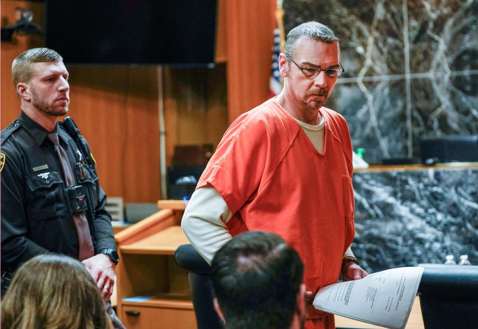 James Crumbley shoots a glance at Assistant Oakland County Prosecutor Joseph Shada as he exits the Oakland County Courtroom of Judge Cheryl Matthews on Wednesday, Feb. 21, 2024. Crumbley will be tried on four counts of involuntary manslaughter in connection with his son, Ethan, who was the perpetrator in a shooting at Oxford High School that killed four students. His wife Jennifer Crumbley was found guilty on all four related counts in this landmark case.