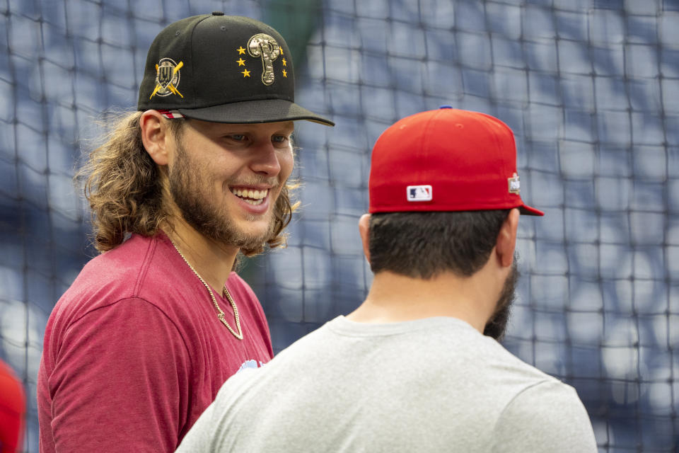 Philadelphia Phillies' Alec Bohm, left, talks with Kyle Schwarber, right, during a baseball workout, Friday, Oct. 4, 2024, in Philadelphia, ahead of the National League Division Series against the New York Mets. (AP Photo/Chris Szagola)