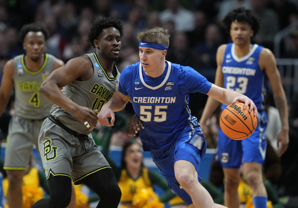 Creighton guard Baylor Scheierman, right, drives past Baylor guard Adam Flagler in the first half of a second-round college basketball game in the men's NCAA Tournament Sunday, March 19, 2023, in Denver. (AP Photo/David Zalubowski)