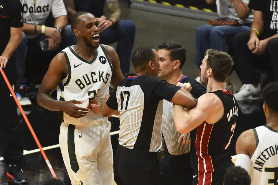 MIAMI, FL - MAY 29: Khris Middleton #22 of the Milwaukee Bucks is seperated from Goran Dragic #7 of the Miami Heat by referee Karl Lane #77 during Game Four of the Eastern Conference first-round playoff series at American Airlines Arena on May 29, 2021 in Miami, Florida. (NOTE TO USER: User expressly acknowledges and agrees that, by downloading and or using this photograph,  User is consenting to the terms and conditions of the Getty Images License Agreement.(Photo by Eric Espada/Getty Images)