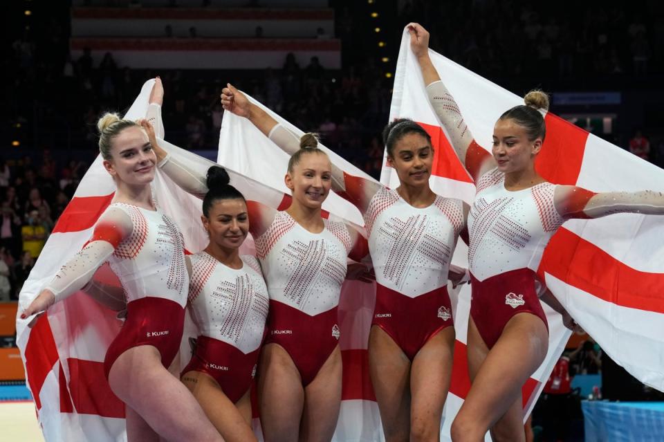 Team England celebrates after winning the gold medal for the women’s team finals (AP)