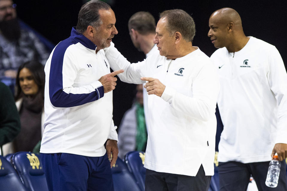 Notre Dame coach Mike Brey, left, and Michigan State head coach Tom Izzo talk before an NCAA college basketball game Wednesday, Nov. 30, 2022, in South Bend, Ind. (AP Photo/Michael Caterina)