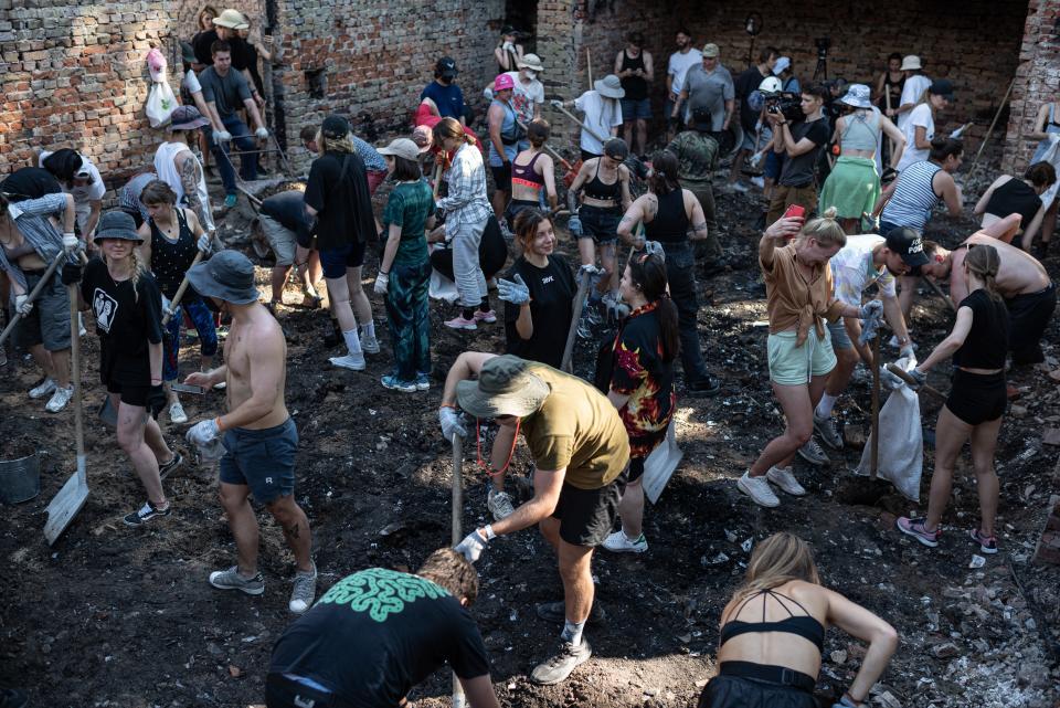 YAHIDNE, UKRAINE - Volunteers of the Repair Together initiative clean the debris inside the Yahidne House of Culture during the Rave Cleanup event. Repair Together is a volunteer initiative to rebuild villages. (Photo by Alexey Furman/Getty Images)