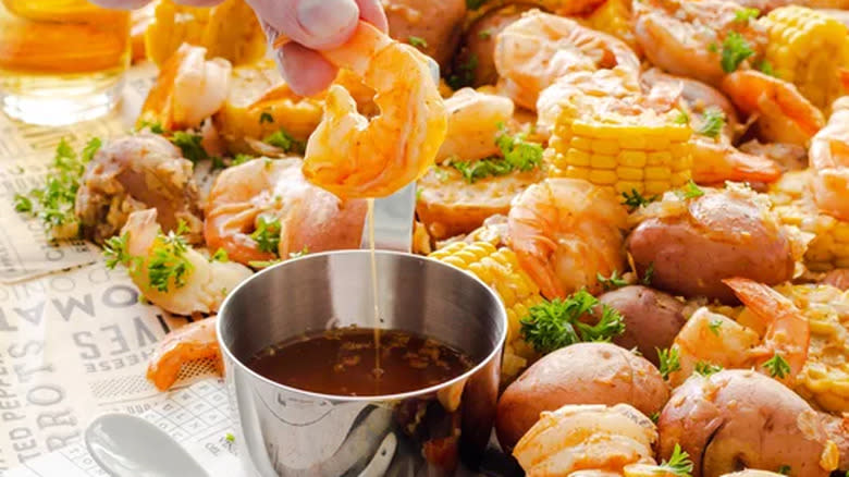 Shrimp boil on paper with dipping sauce