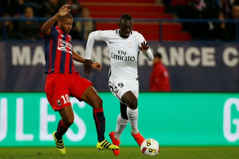 Paris Saint-Germain's French forward Jean-Kevin Augustin (R) vies for the ball with Caen's French-Beninese midfielder Jordan Adeoti during the French L1 football match between Caen and Paris Saint-Germain