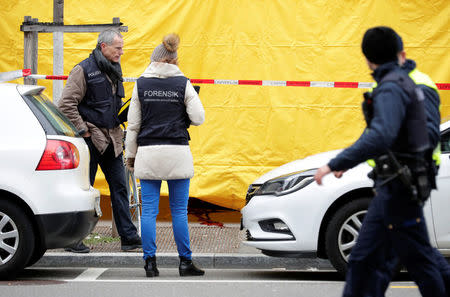 Police investigate a crime scene after two people, police said, were killed in Zurich, Switzerland, February 23, 2018. REUTERS/Moritz Hager