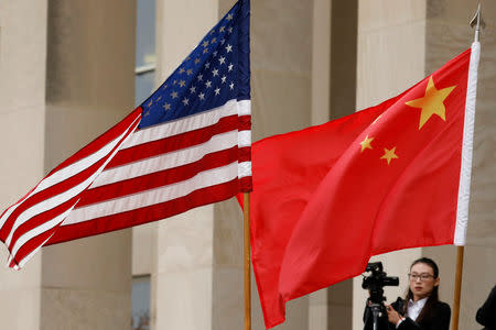 FILE PHOTO - U.S. and Chinese flags are seen before Defense Secretary James Mattis welcomes Chinese Minister of National Defense Gen. Wei Fenghe to the Pentagon in Arlington, Virginia, U.S., November 9, 2018. REUTERS/Yuri Gripas